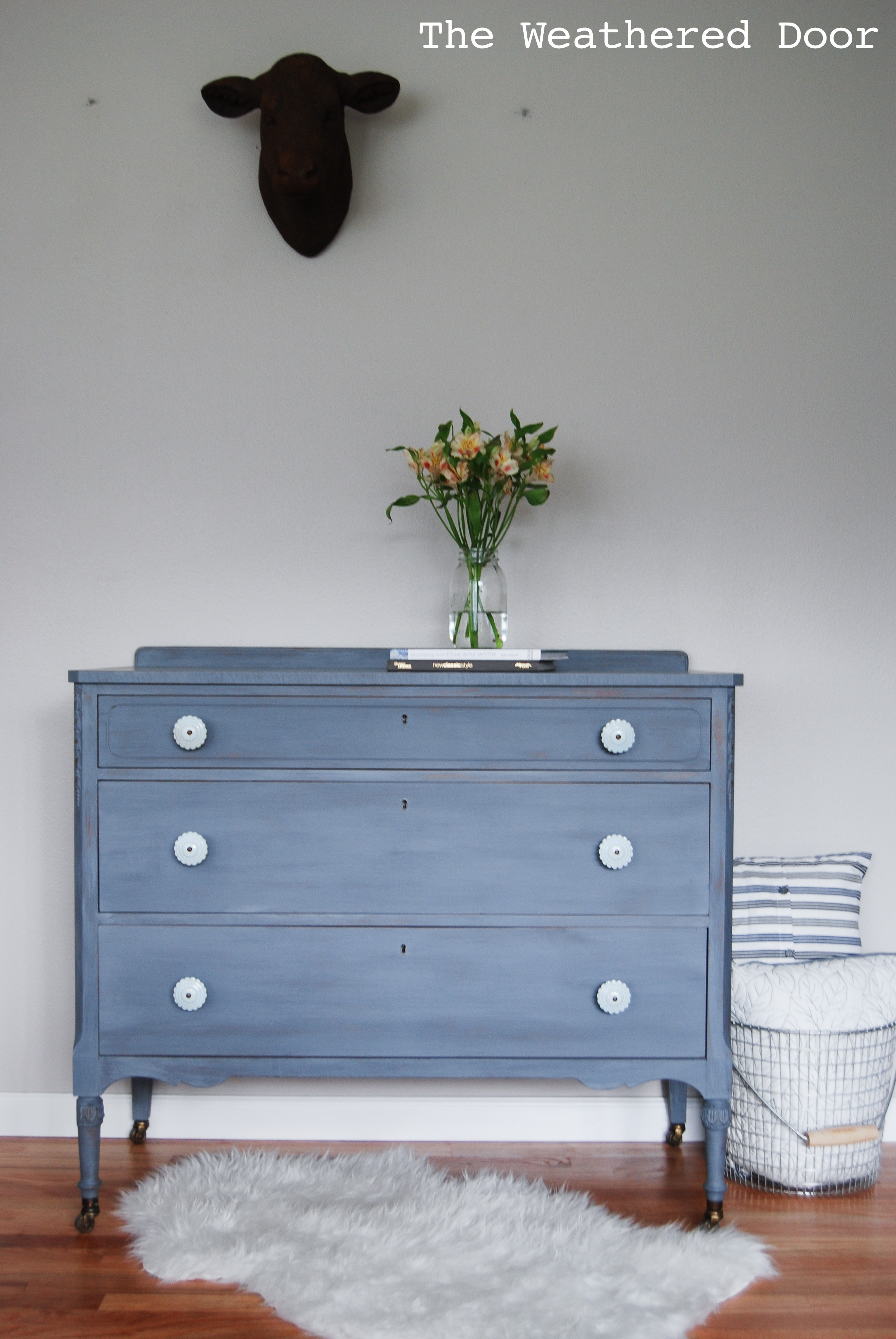 A Grey Blue Purple Dresser With Soft Blue Knobs The